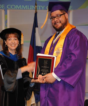 Dr. Diana Doyle, president of ACC, presents student of the year award to John Whatley.