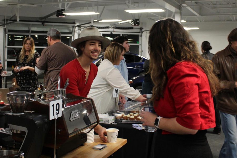 Tyler Venter of Spur Coffee provides Camila Monroe, student of Arapahoe Community College, with a cappuccino during the Grapes & Hops to Grads fundraiser on Wednesday, Nov. 8, 2017 in Highlands Ranch, Colo.