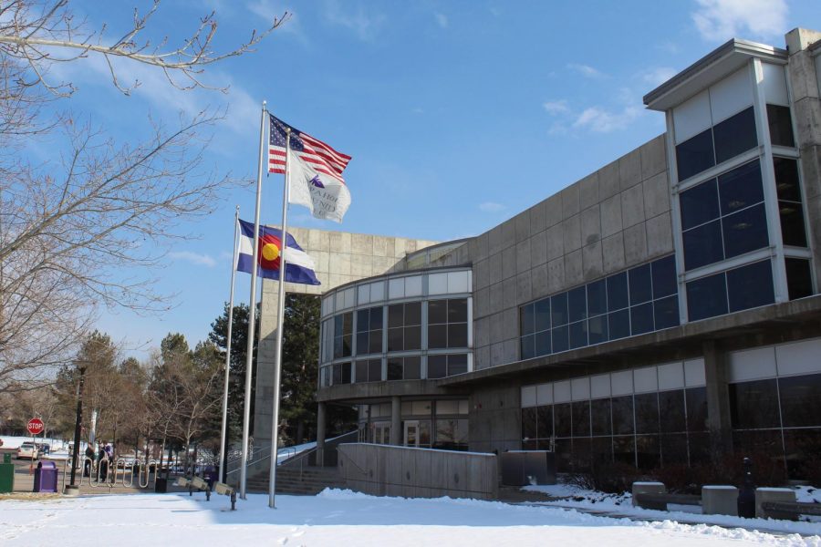 Flags wave near the north entrance of Arapahoe Community Colleges main building on the Littleton campus.