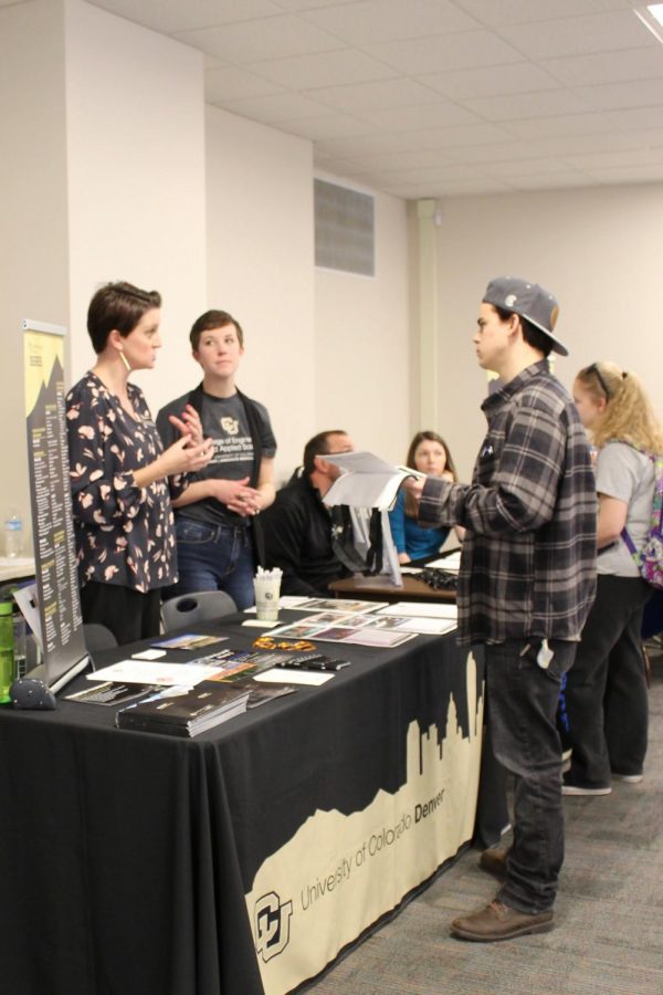 Erica Lefeave and Kate Seppala speak with Xander Elea, first-year student at Arapahoe Community College, about the engineering programs offered at the University of Colorado Denver during the Spring Transfer Fair in Littleton, Colo. on Tuesday, Feb. 27, 2018. Over 35 transfer advisors from local and national four-year universities were available to speak with students.