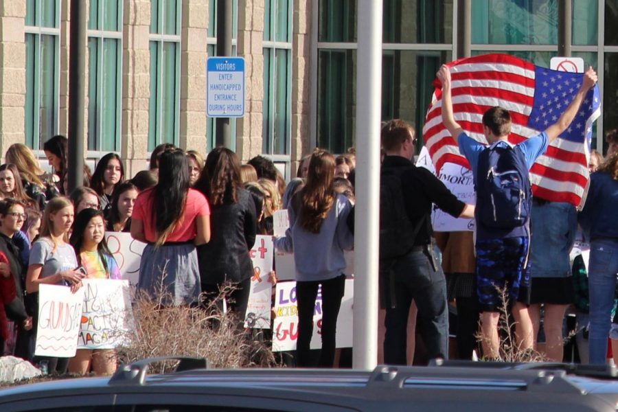 ThunderRidge students assemble in front of their high school on Wednesday, March 14, 2018, in Highlands Ranch, Colo. to express their concerns in the wake of the Parkland, Fla. shooting. 