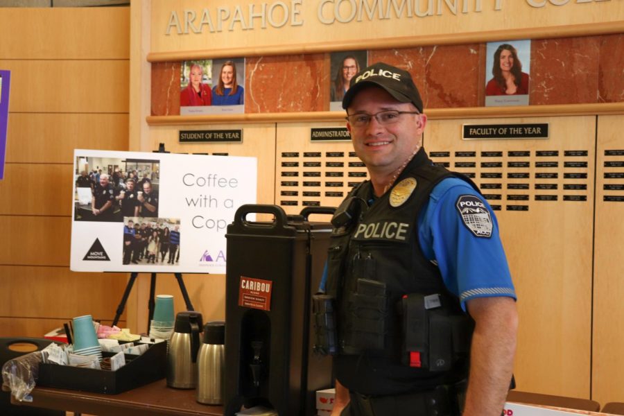 Officer K. Heylin takes a moment to pose in front of the Caribou Coffee and sign for Coffee with a Cop on Tuesday April 9th, 2019. 