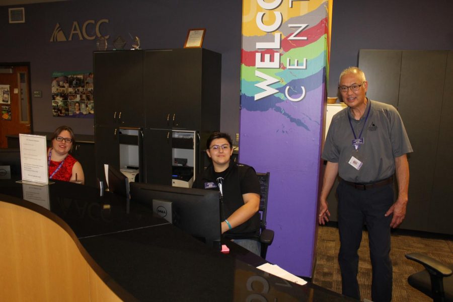Jennifer Sheldon (left) and Charles Frank (middle) and Howard Fukaye (right, not featured in this article) working behind the ACC Welcome Center Desk in the midst of their many daily duties. Image via Jaymes Grundmann