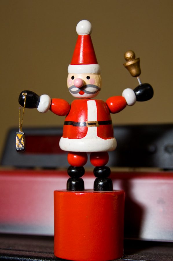 A slingbox santa figure on display. These old fashion toy is a representation of times past/