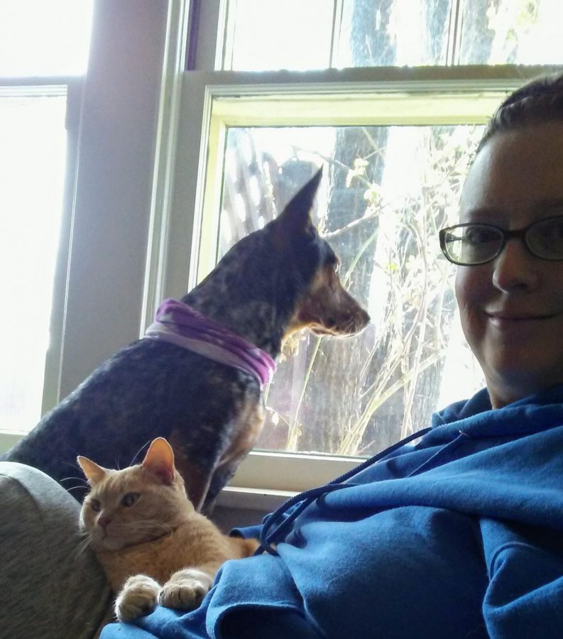 Amy Wilkerson sitting in front of a window with her dog Lina and her cat Nigel on April 16, 2020. Wilkerson works as a psychology faculty member at ACC.
