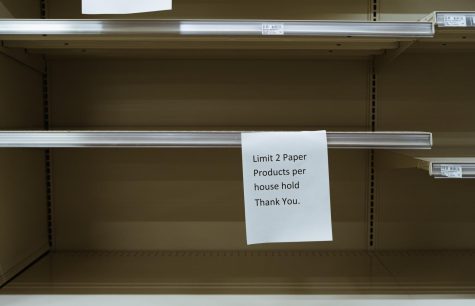 A white paper hung up at grocery store on March 27, 2020. It is posted in the paper isle limiting households of only two paper products. 