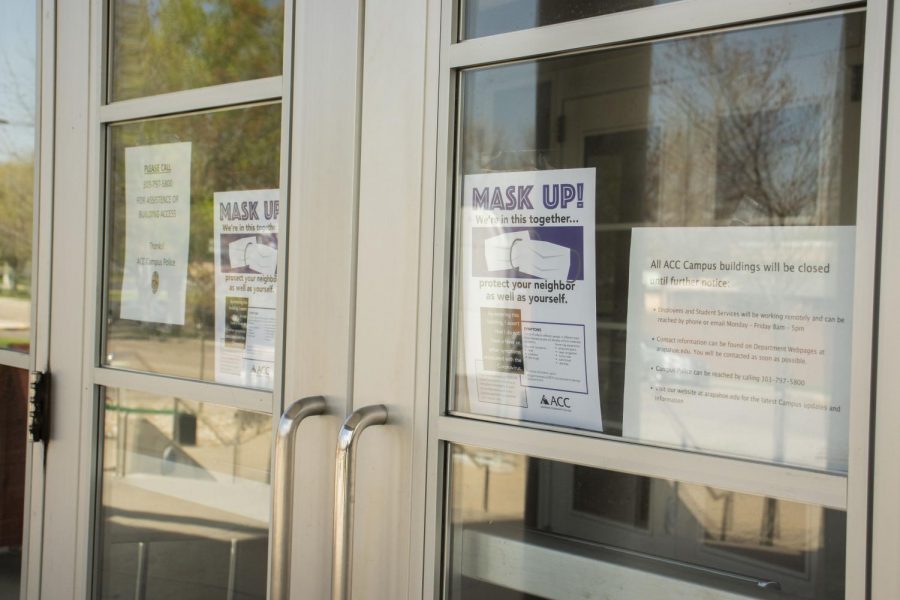 Different COVID-19 signs posted in the front of ACCs main building on Tuesday, May 12, 2020. The signs are specifying the importance of wearing masks before entering.