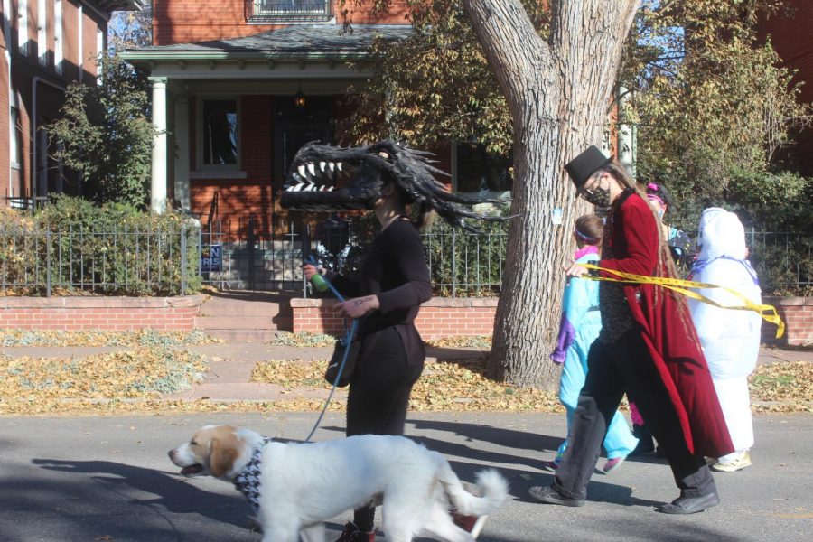 A monster, a magician, and the Michelin Man and their dog walk participate in the Halloween parade in the Highlands neighborhood on Halloween Day;. Oct 31 2020 
