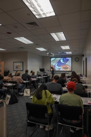 The classroom watches as librarian Lara Beckwith demonstrates