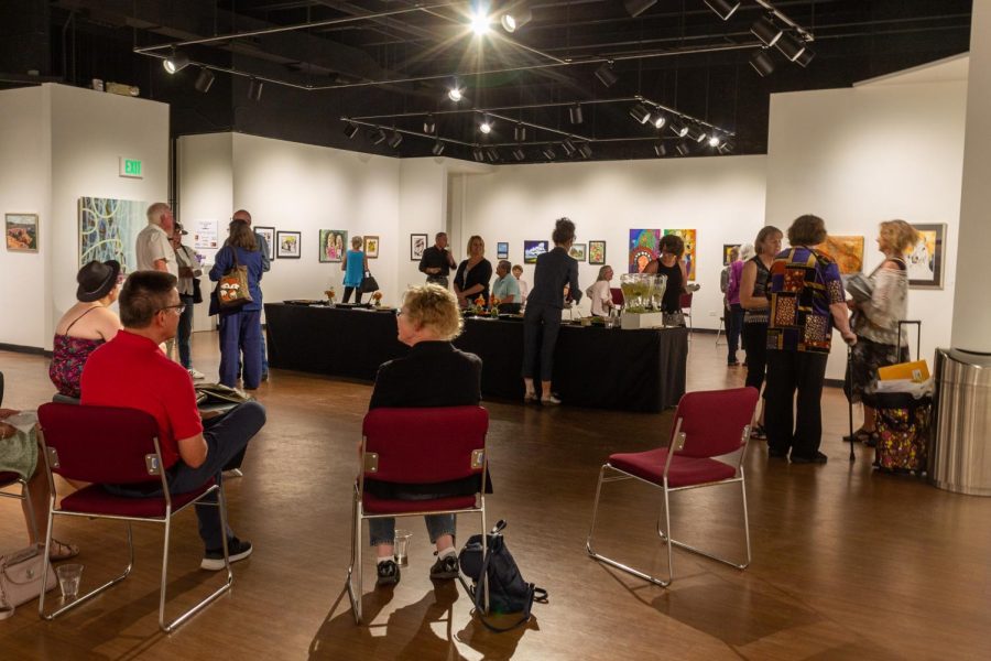 Artists conversate with one another as the reception attendance gradually increases.