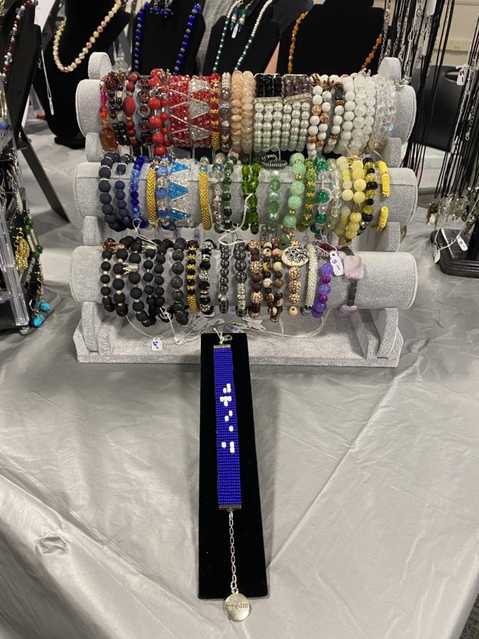A closeup of the bracelets at Sarah Gigler’s booth. Gigler is an English teacher at ACC. One bracelet spells the word dream in braille. Image taken at ACC’s Holiday Fair on Nov. 3, 2022.