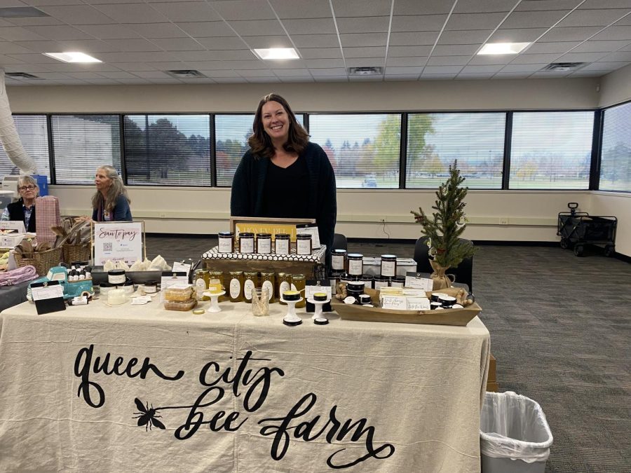 Keysha Boggess, owner of Queen City Bee Farm and ACC Career and Transfer Services, work-based learning coordinator, standing behind her booth. The both was full of honey, candles and lotion. Boggess is in her fifth season of beekeeping and has turned her passion into a business. Image taken at ACC’s Holiday Fair on Nov. 3, 2022.