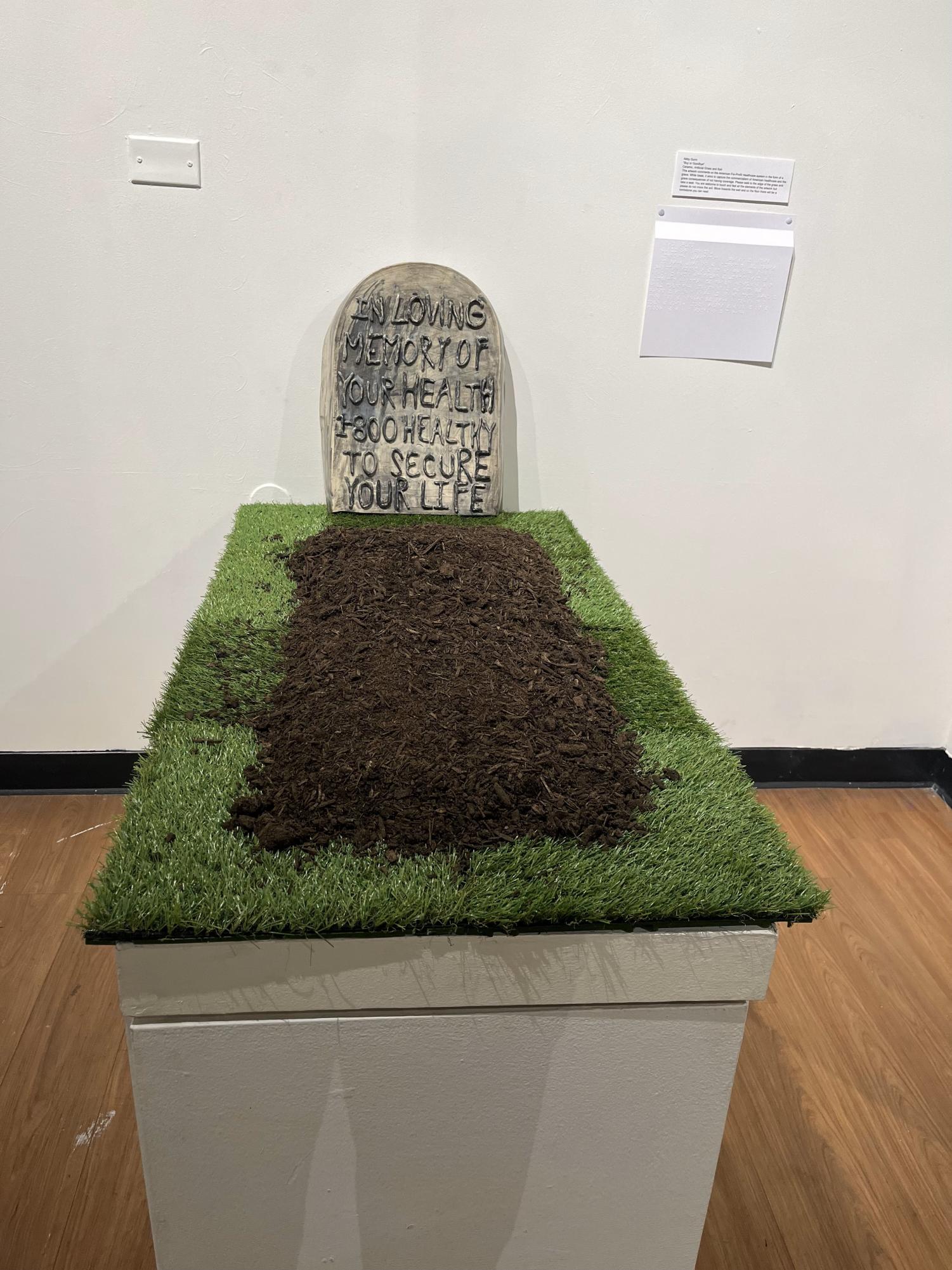 Abby Gunns work titled Buy or Goodbye comments on the grave consequences of not having healthcare coverage in America. Gunn encourages viewers to sit on the edge of the grass and feel the elements of the artwork.