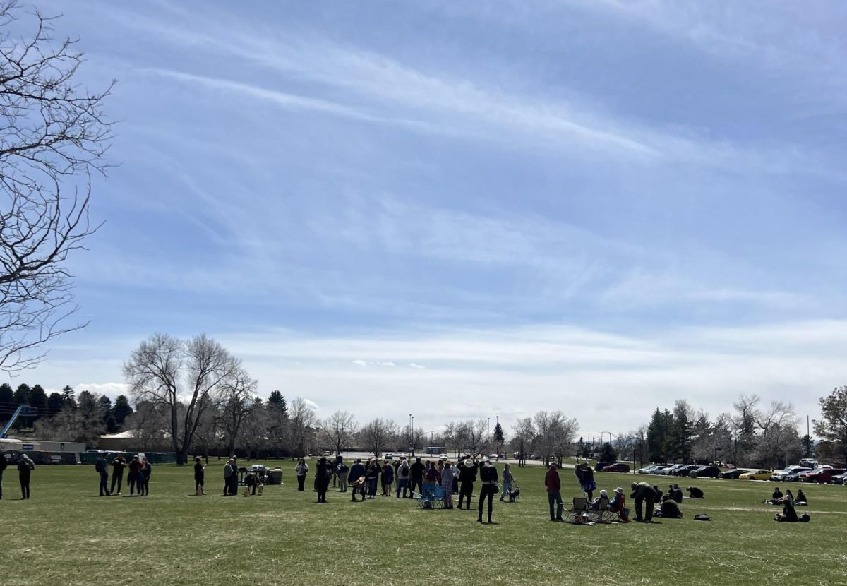 People gather to watch for the solar eclipse viewing party hosted by the astronomy department at Arapahoe Community College on Monday, April 8, 2024.