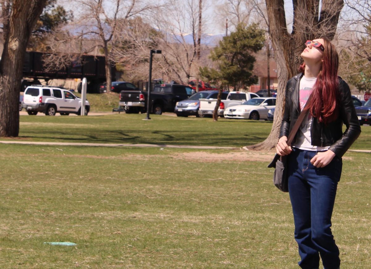 Arapahoe Community College concurrent enrollment student Everett Bithell looks up at solar eclipse viewing on the west lawn at Arapahoe Community College on April 8, 2024.