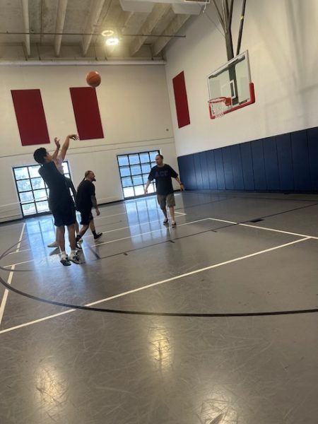 Student shoots a basketball trying to get a point for his team