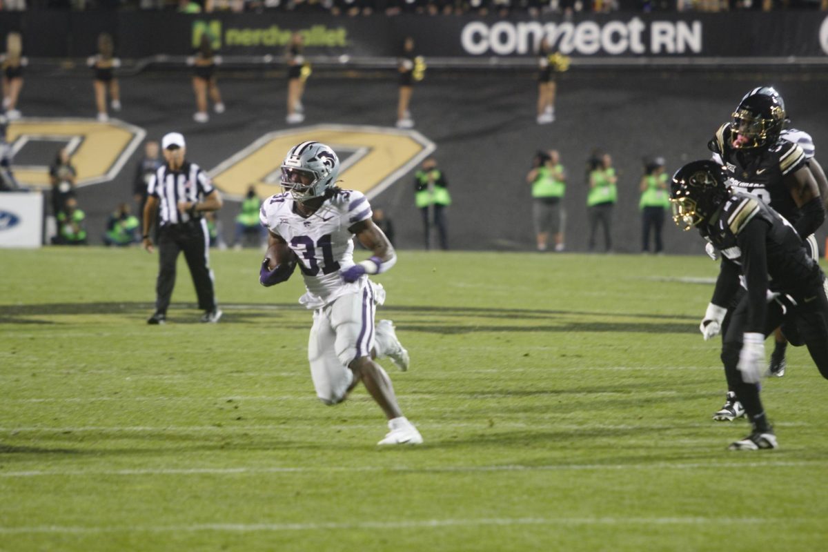 Runningback, DJ Giddens takes the ball upfield.