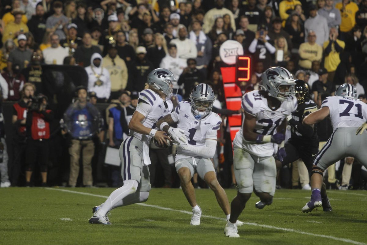 Wide Receiver, Jayce Brown takes the football from the quarterback before rushing upfield.