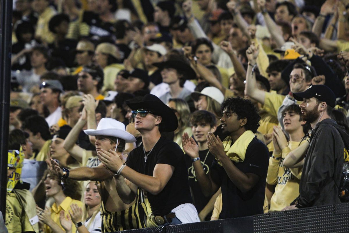 Colorado fans cheer as the CU offense pushes up the field towards the end zone.