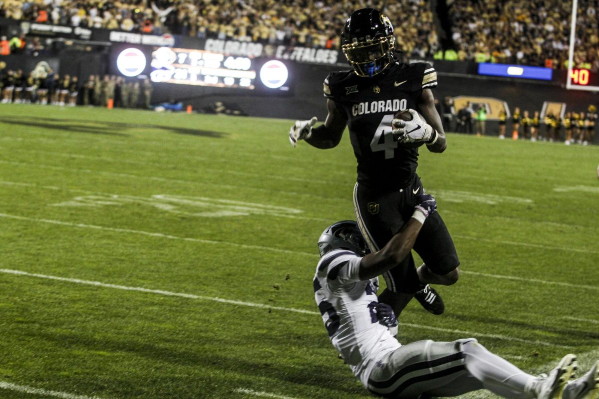 Running back, Joe Jackson is brought down by a Kansas State defender setting up a touchdown drive by the CU offense.