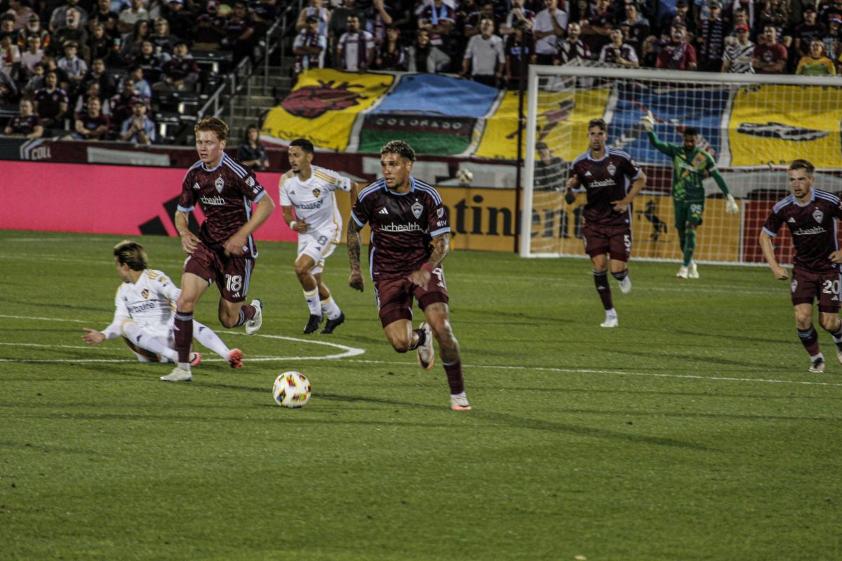 Forward, Rafael Navarro, and fellow teammates press the ball up the field after winning a challenge against LA Galaxy midfield, Riqui Puig during the Colorado Rapids 1-3 loss against LA Galaxy.