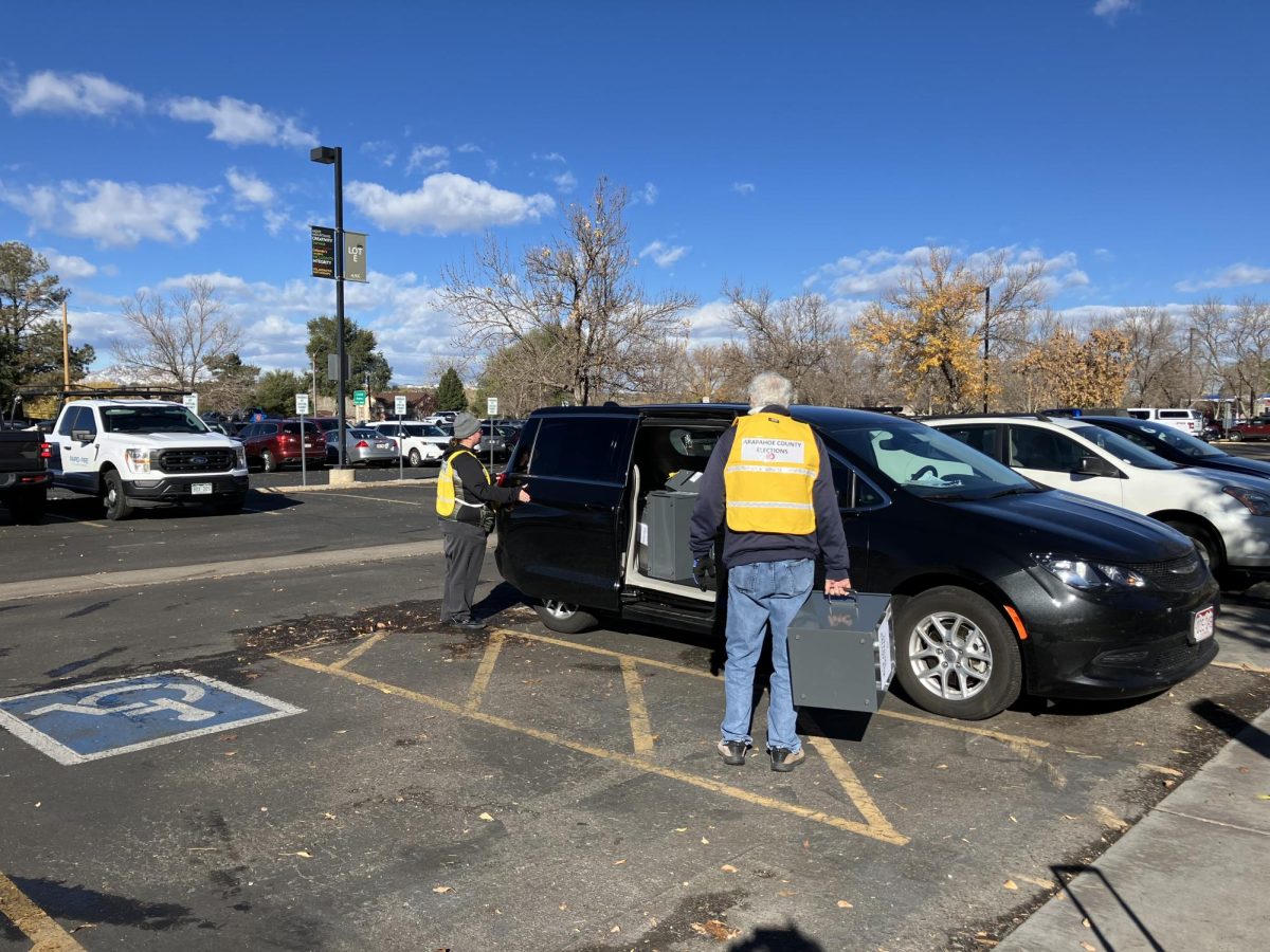 Arapahoe County election officials load ballot boxes into a vehicle on November 5, 2024. Arapahoe Community College is a voting center.