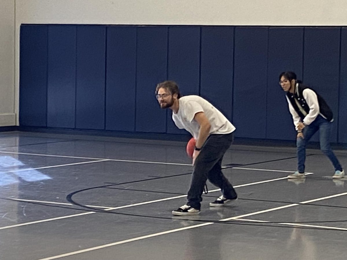 Joseph a student at ACC is rolling the ball as a pitcher 