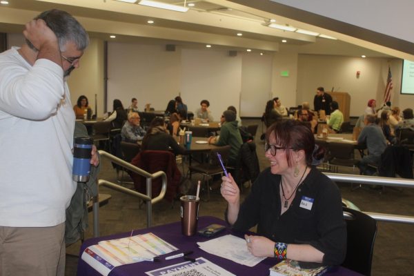 English Professor Monica Fuglei checks in alumni Nathan Moreno at ACC's annual Writers Studio Lit Fest in Littleton, Colo on Feb 22 2025.
